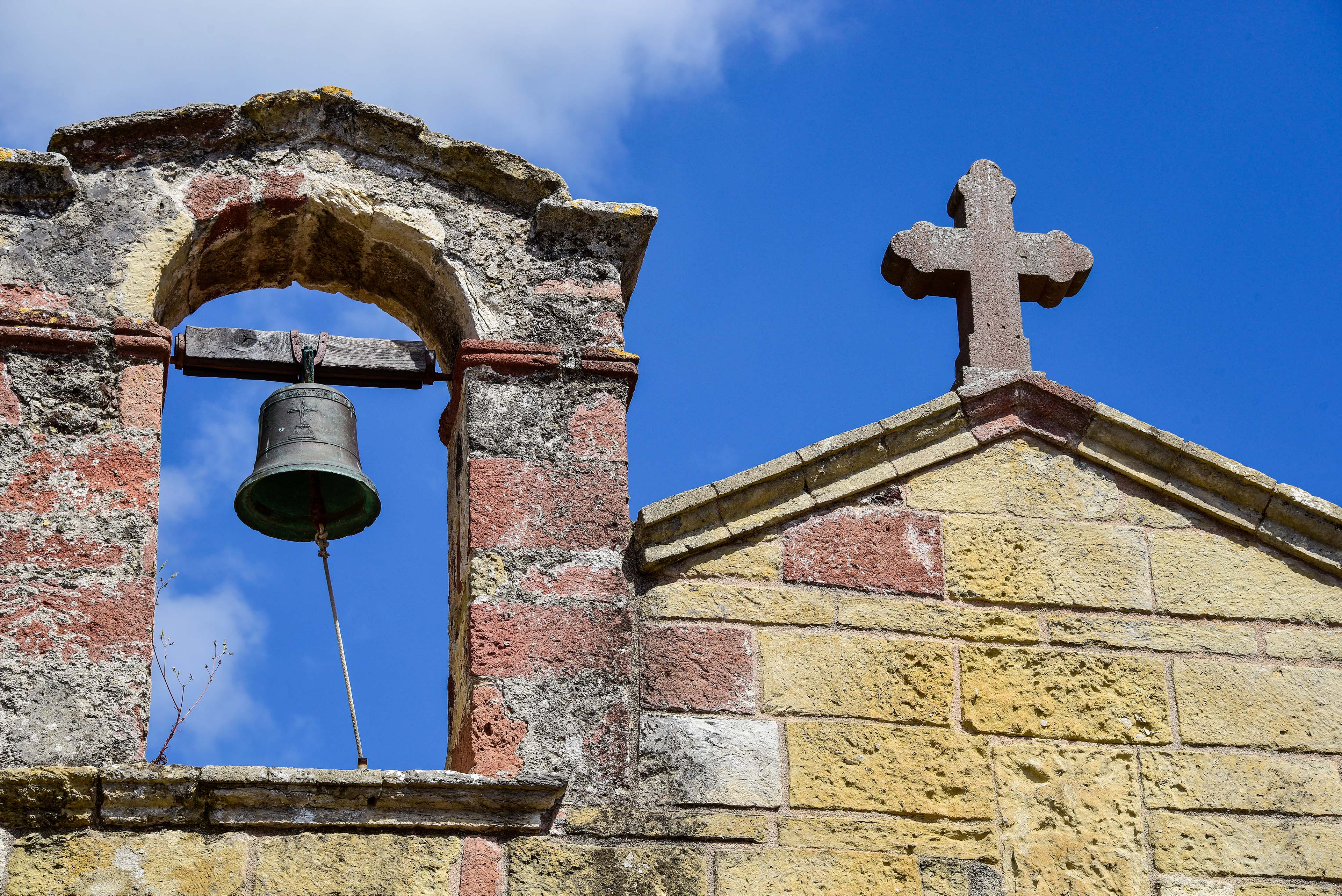 Particolare della parte alta del prospetto frontale con la croce e il campaniletto a vela